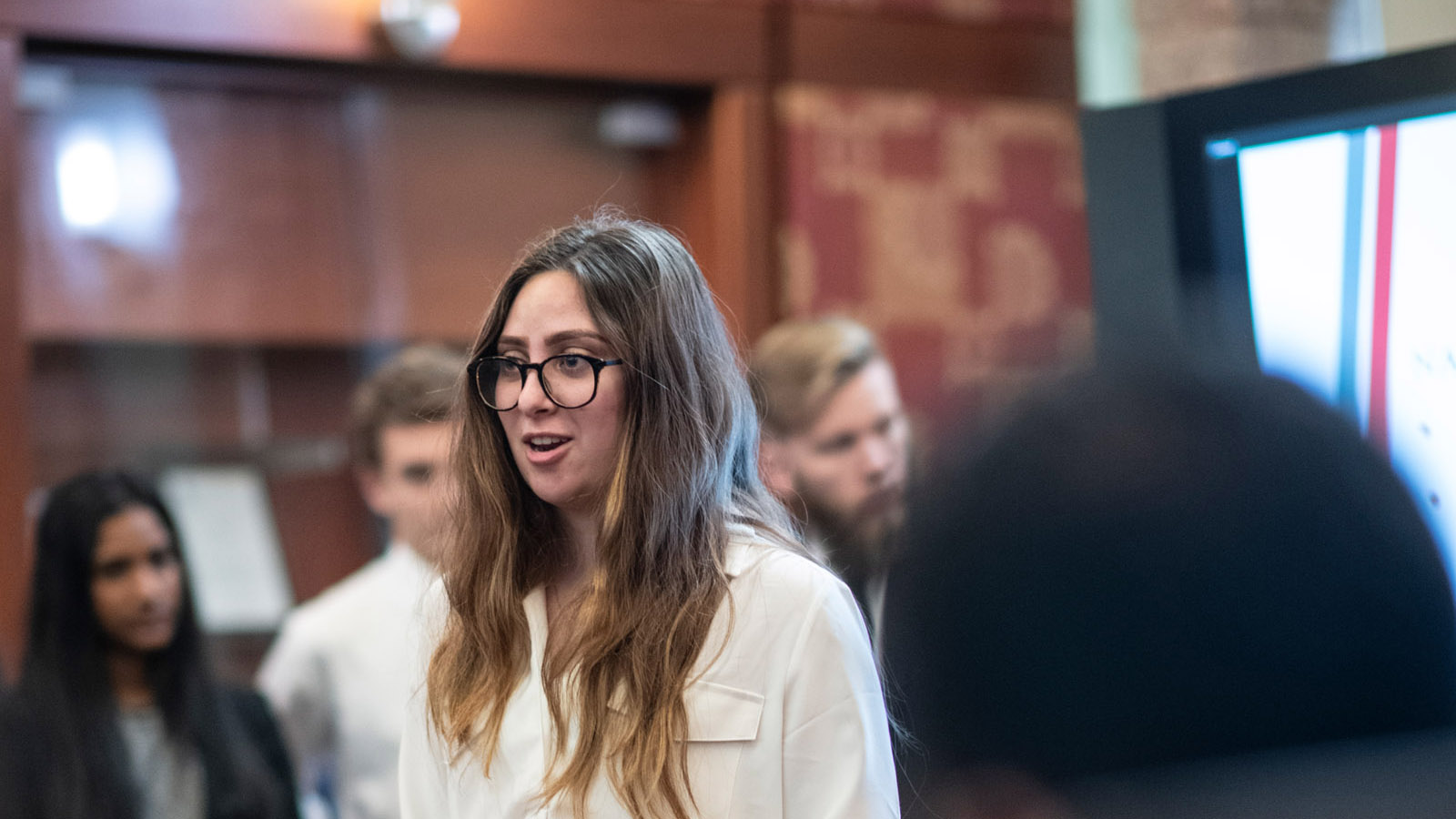 Student presenting findings to stakeholders in Frisco