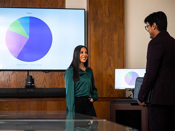 Students talking about a presentation. 