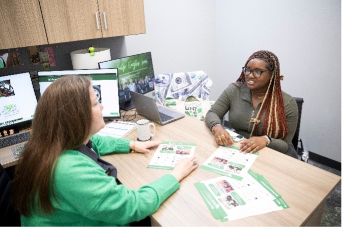 Money coach working with student.